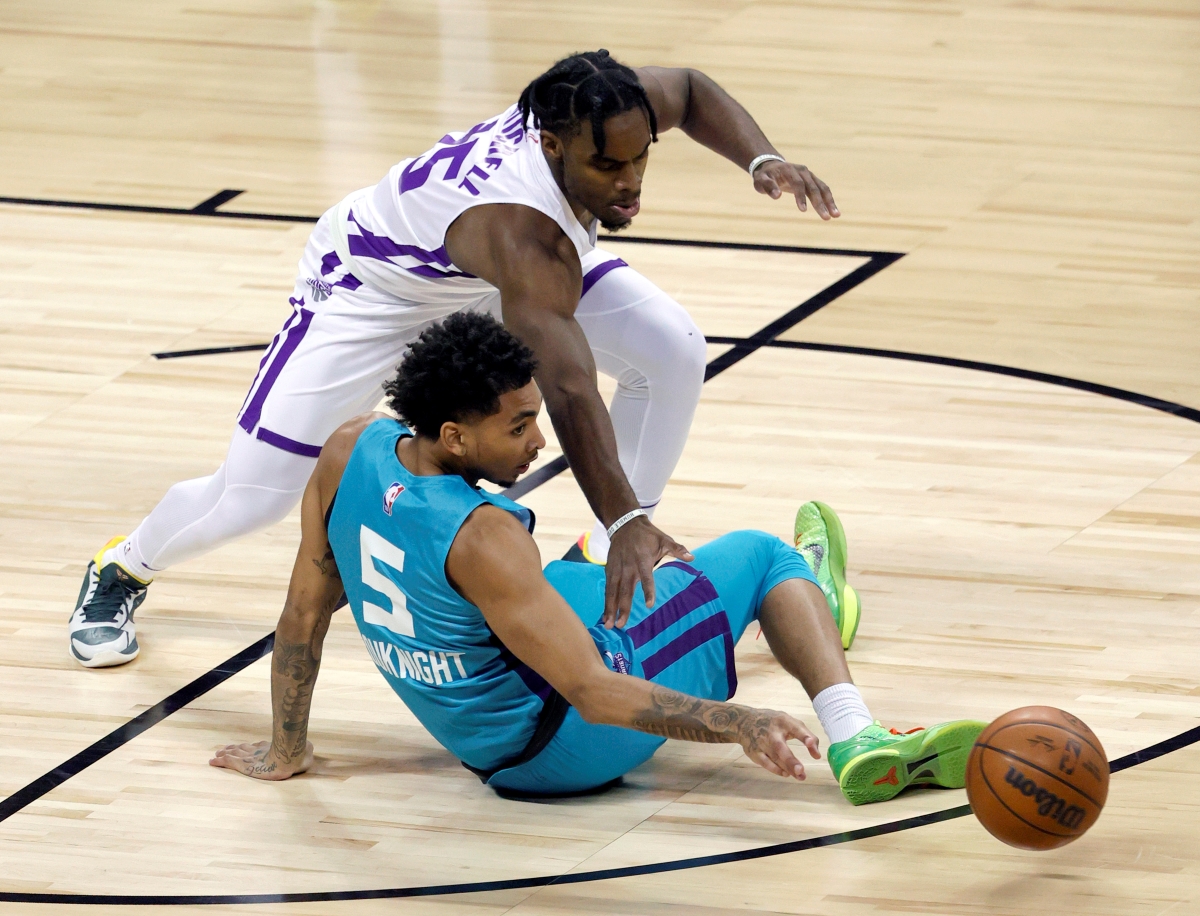 Davion Mitchell of the Sacramento Kings steals a ball from the Charlotte Hornets' James Bouknight.
