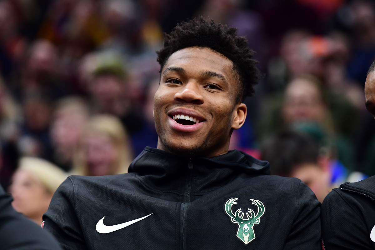 Giannis Antetokounmpo of the Milwaukee Bucks jokes with a teammate on the bench. Antetokounmpo recently bought a stake in the Milwaukee Brewers franchise.