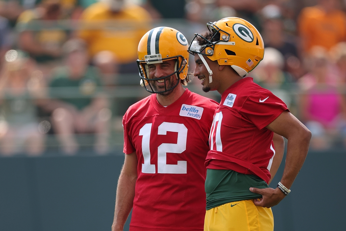 Green Bay Packers' quarterbacks Jordan Love and Aaron Rodgers chat during a training camp practice.