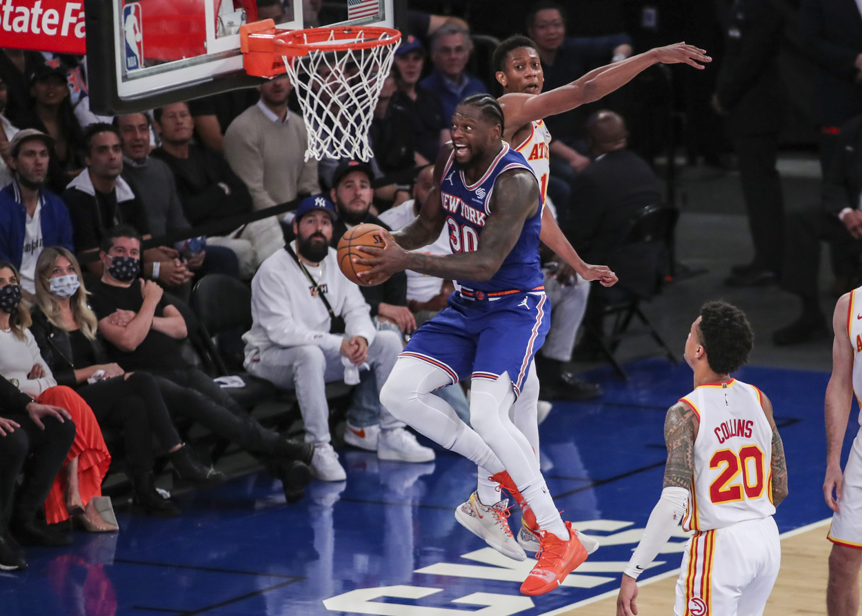 Julius Randle flies through the air for an acrobatic lay-up in a playoff game against the Hawks.