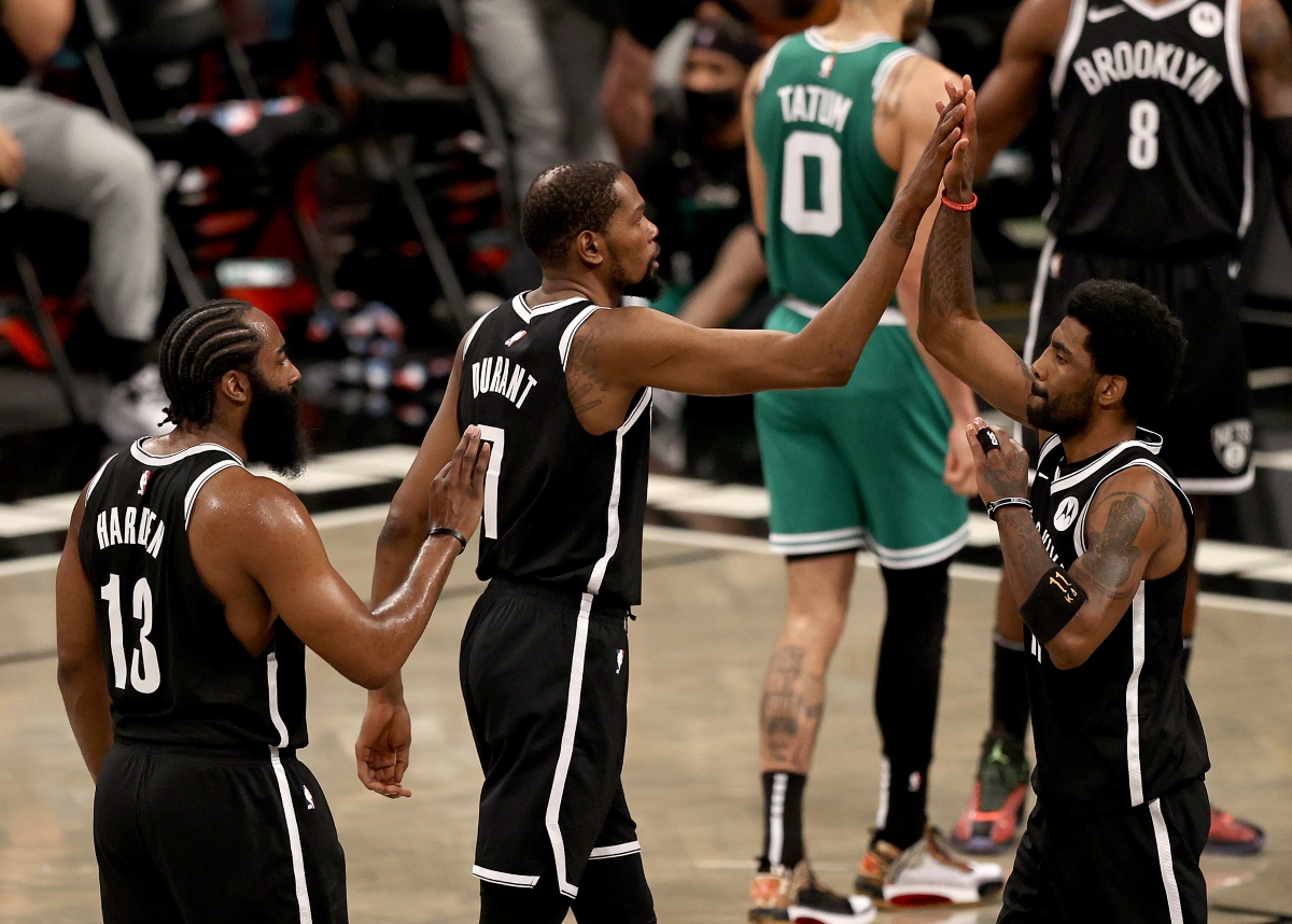 Kevin Durant and James Harden of the Brooklyn Nets congratulate teammate Kyrie Irving.