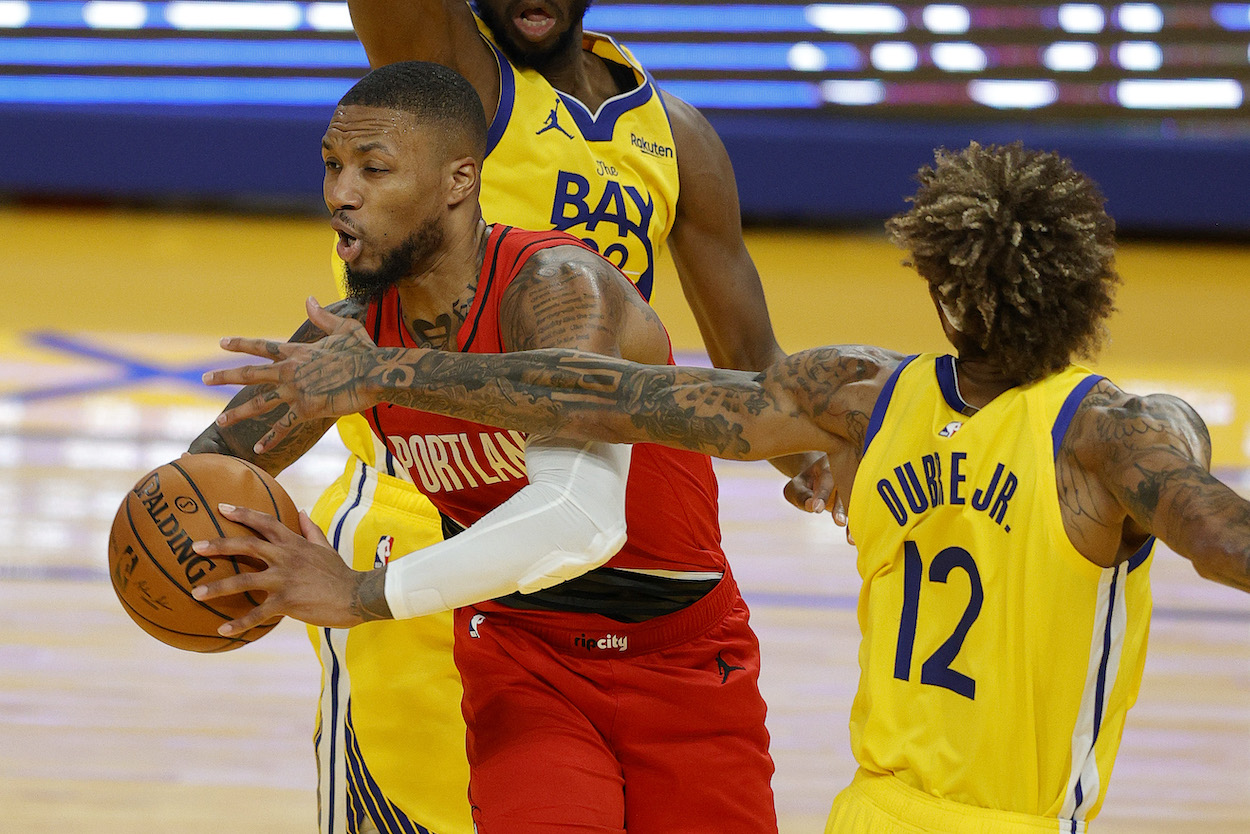 Damian Lillard being defended by Kelly Oubre.