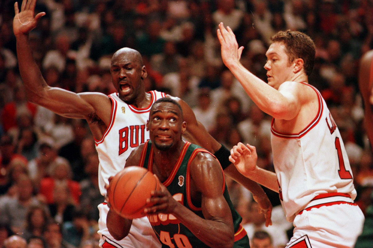 Michael Jordan and Luc Longley of the Chicago Bulls double-team Shawn Kemp of the Seattle SuperSonics during the 1996 NBA Finals.