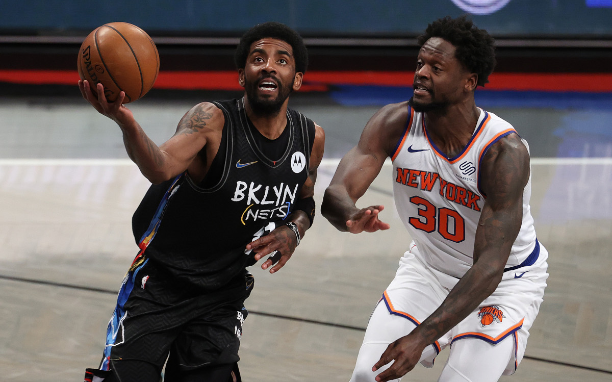 Kyrie Irving of the Brooklyn Nets defended by Julius Randle of the New York Knicks