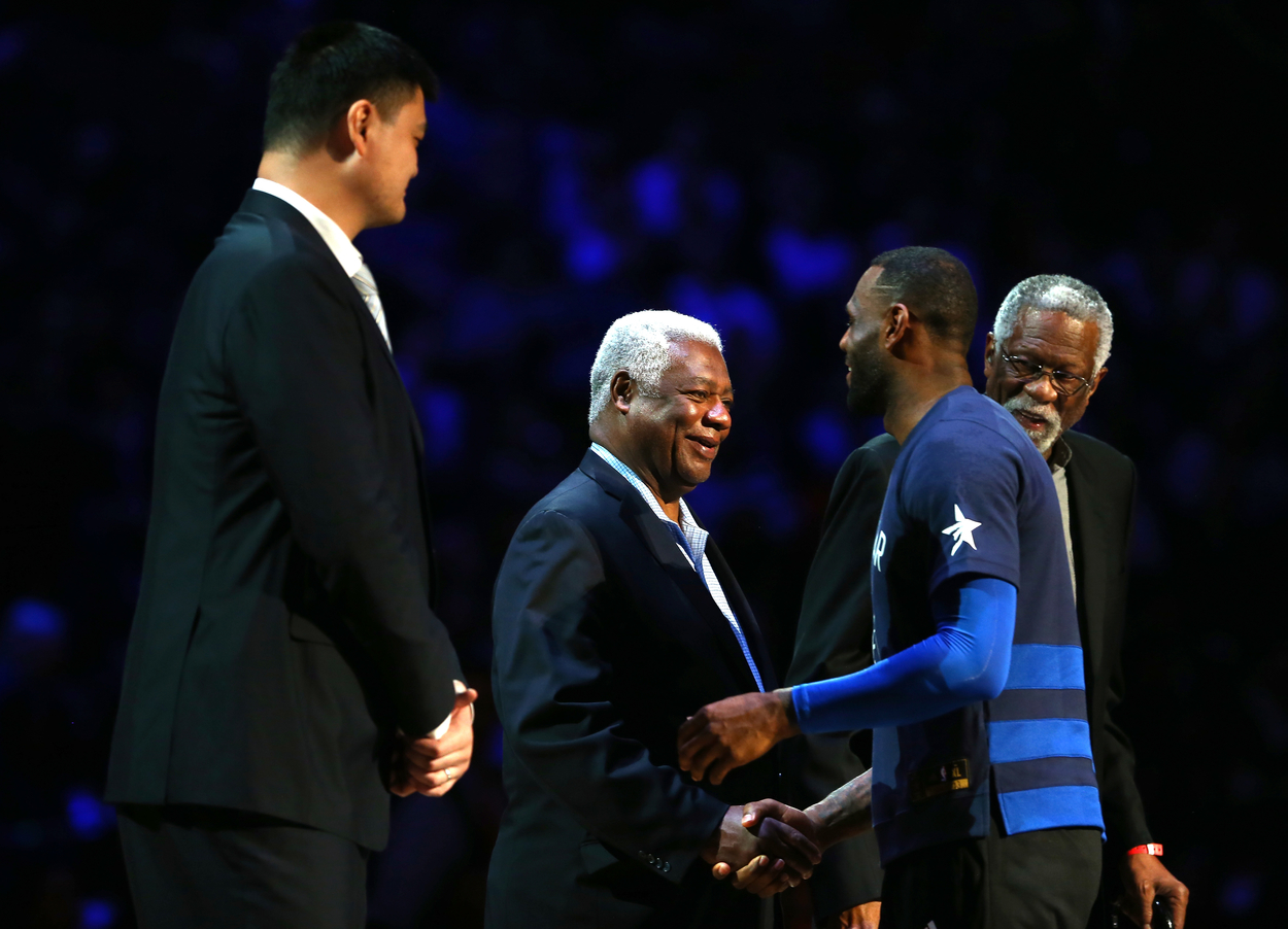 LeBron James goes in for a handshake with Oscar Robertson as Bill Russell and Yao Ming stand to the side and observe.