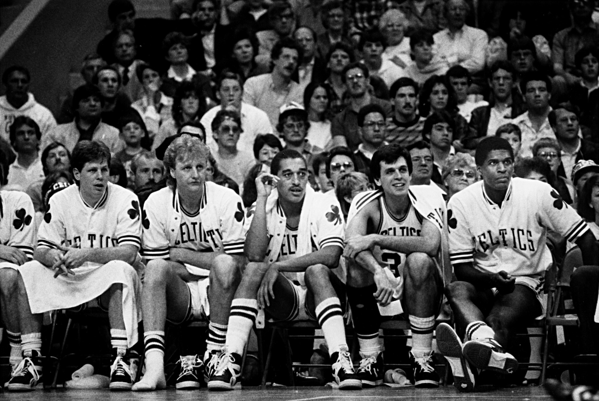 Danny Ainge, Larry Bird, Dennis Johnson, Kevin McHale, and Robert Parish sit on the bench during a Celtics-Nets game in 1986