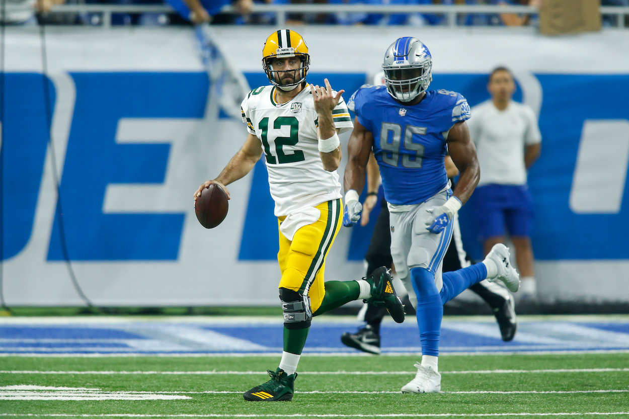 Green Bay Packers quarterback Aaron Rodgers looks for a receiver during a regular season game between the Green Bay Packers and the Detroit Lions on October 7, 2018 at Ford Field in Detroit, Michigan.