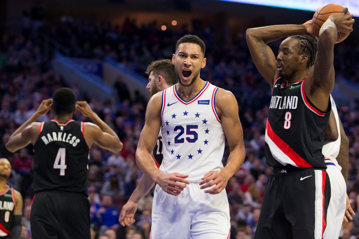 Ben Simmons of the Philadelphia 76ers reacts in front of Maurice Harkless and Al-Farouq Aminu of the Portland Trail Blazers.