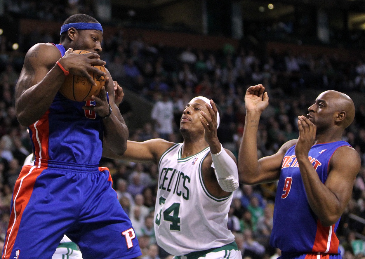 Detroit Pistons center Ben Wallace (#6) pulls down an offensive rebound in front of Boston Celtics small forward Paul Pierce.