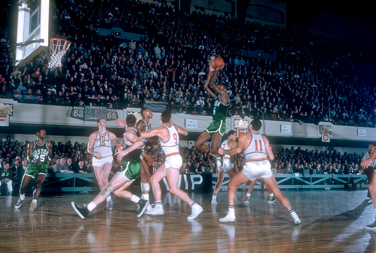 Bill Russell of the Boston Celtics goes for the shot.