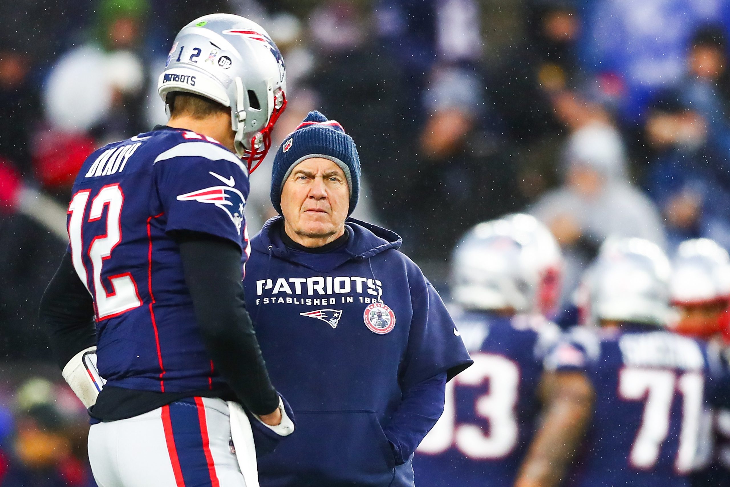 Tom Brady talks to head coach Bill Belichick of the New England Patriots before a game.