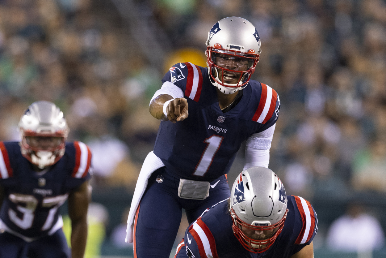 Cam Newton of the New England Patriots points against the Philadelphia Eagles in the preseason game at Lincoln Financial Field on August 19, 2021. .