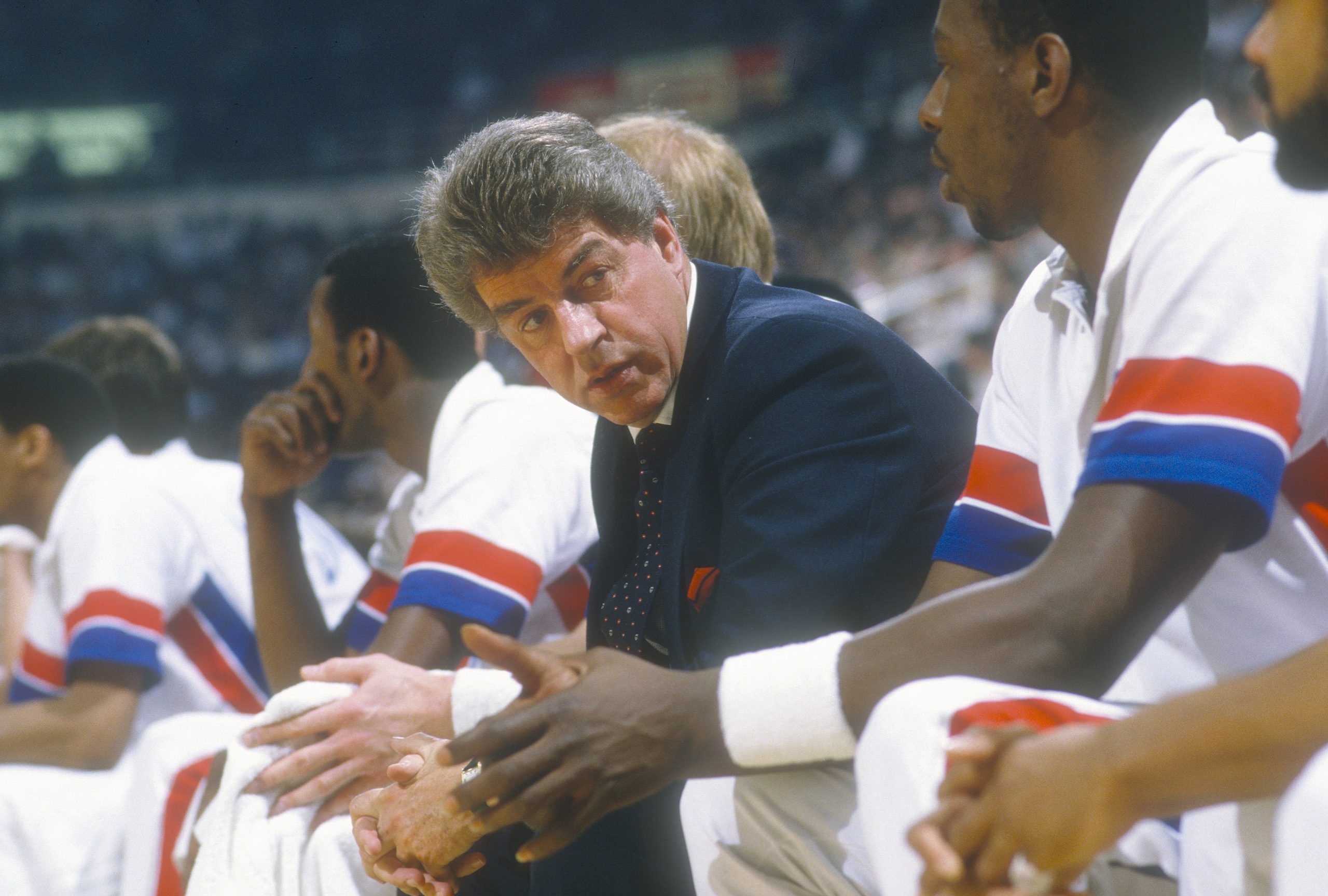 Head coach Chuck Daly of the Detroit Pistons looks down his bench.