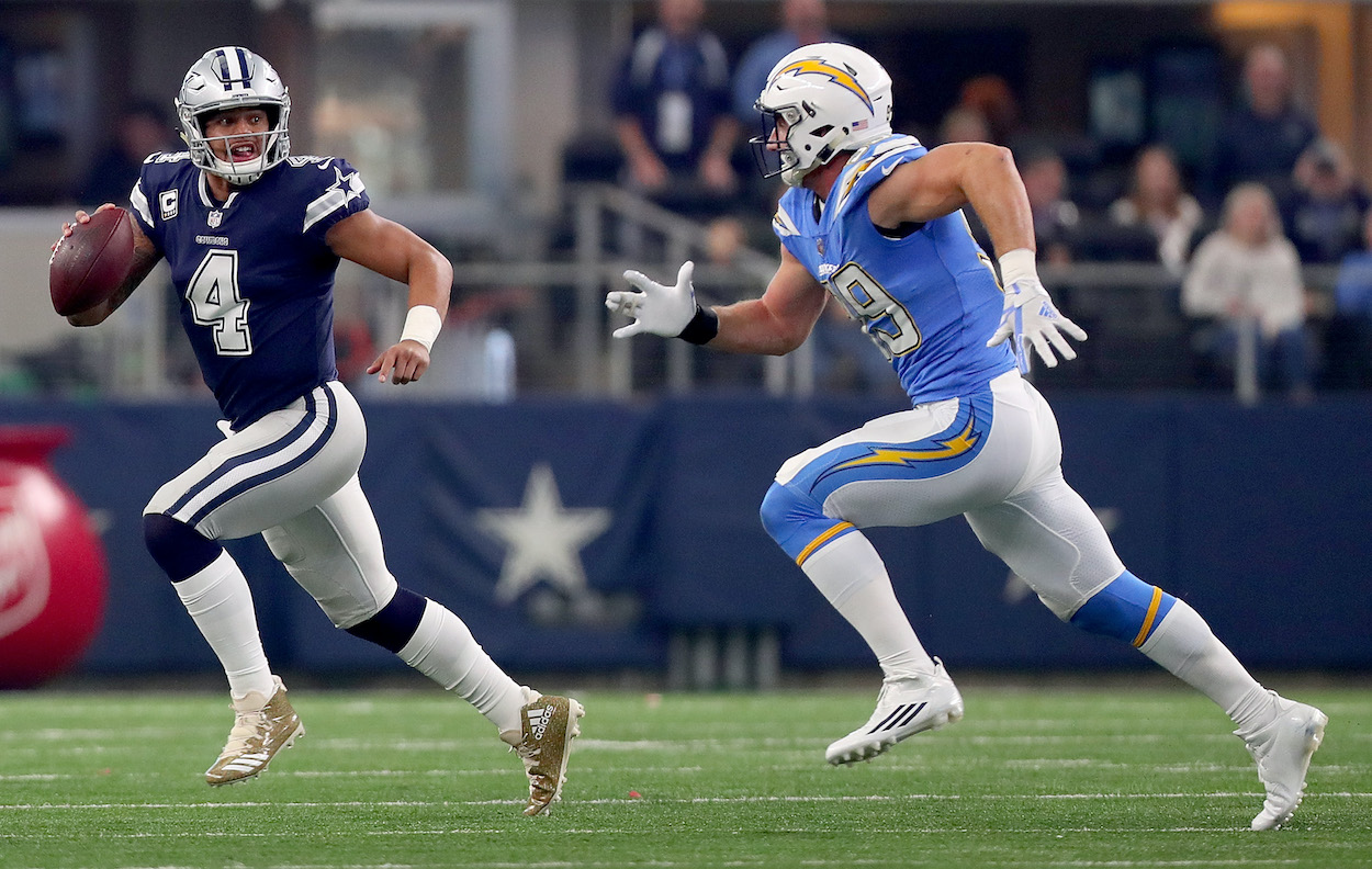 Dak Prescott of the Dallas Cowboys scrambles under pressure from Joey Bosa of the Los Angeles Chargers in the first quarter of a football game at AT&T Stadium on November 23, 2017 in Arlington, Texas. The two teams will face-off again during the 2021 NFL Week 2 slate.