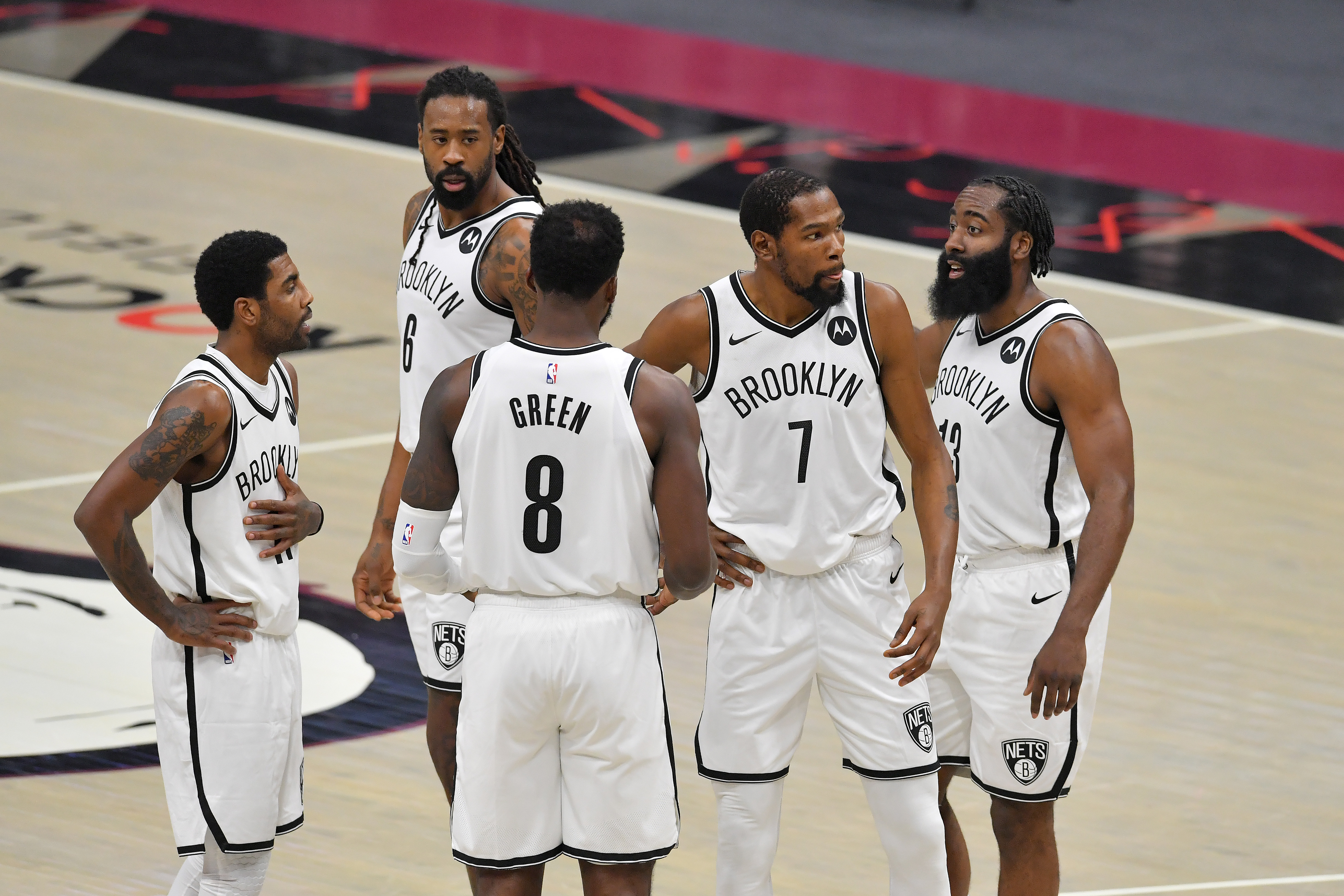 Kevin Durant, Kyrie Irving, DeAndre Jordan, and the Nets huddle during a game against the Cleveland Cavaliers