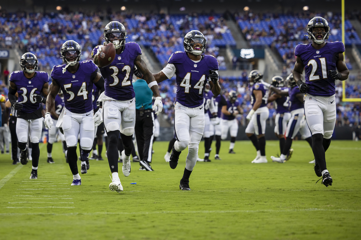 DeShon Elliott, Chuck Clark, and the Ravens defense celebrates after a turnover