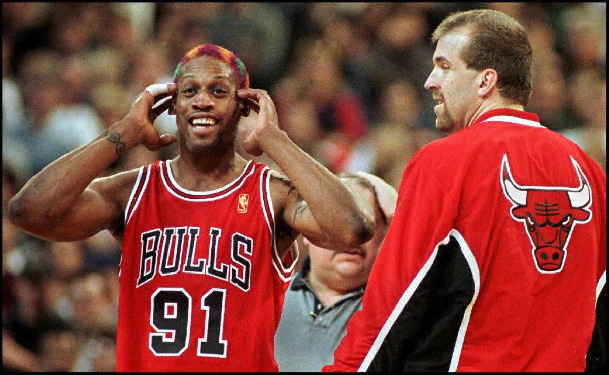 Bulls player Dennis Rodman laughs as he gets ejected from an NBA
