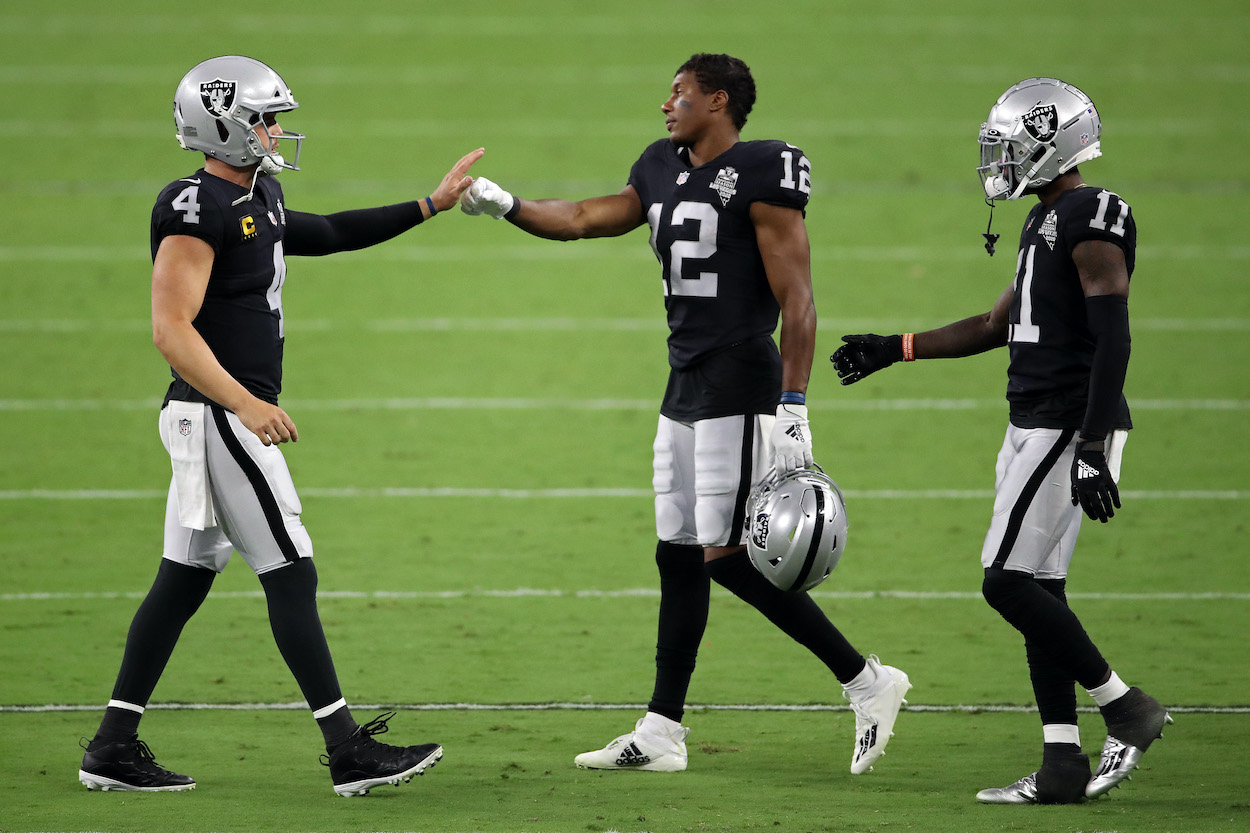 Derek Carr of the Las Vegas Raiders reacts with Zay Jones, and Henry Ruggs III against the New Orleans Saints at Allegiant Stadium on September 21, 2020 in Las Vegas, Nevada.