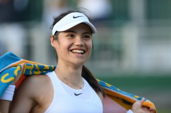 Tennis player Emma Raducanu of Great Britain smiles as she walks off the court after a match at Wimbledon 2021 in London, England | Mike Hewitt/Getty Images