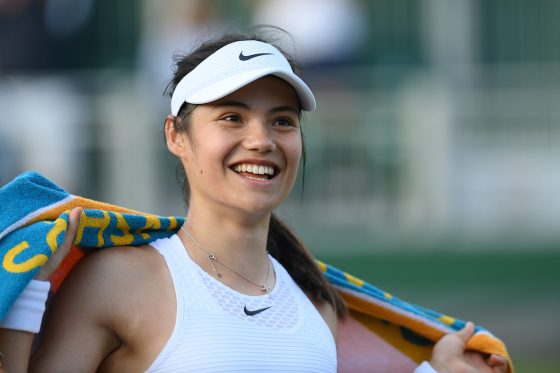 Tennis player Emma Raducanu of Great Britain smiles as she walks off the court after a match at Wimbledon 2021 in London, England | Mike Hewitt/Getty Images