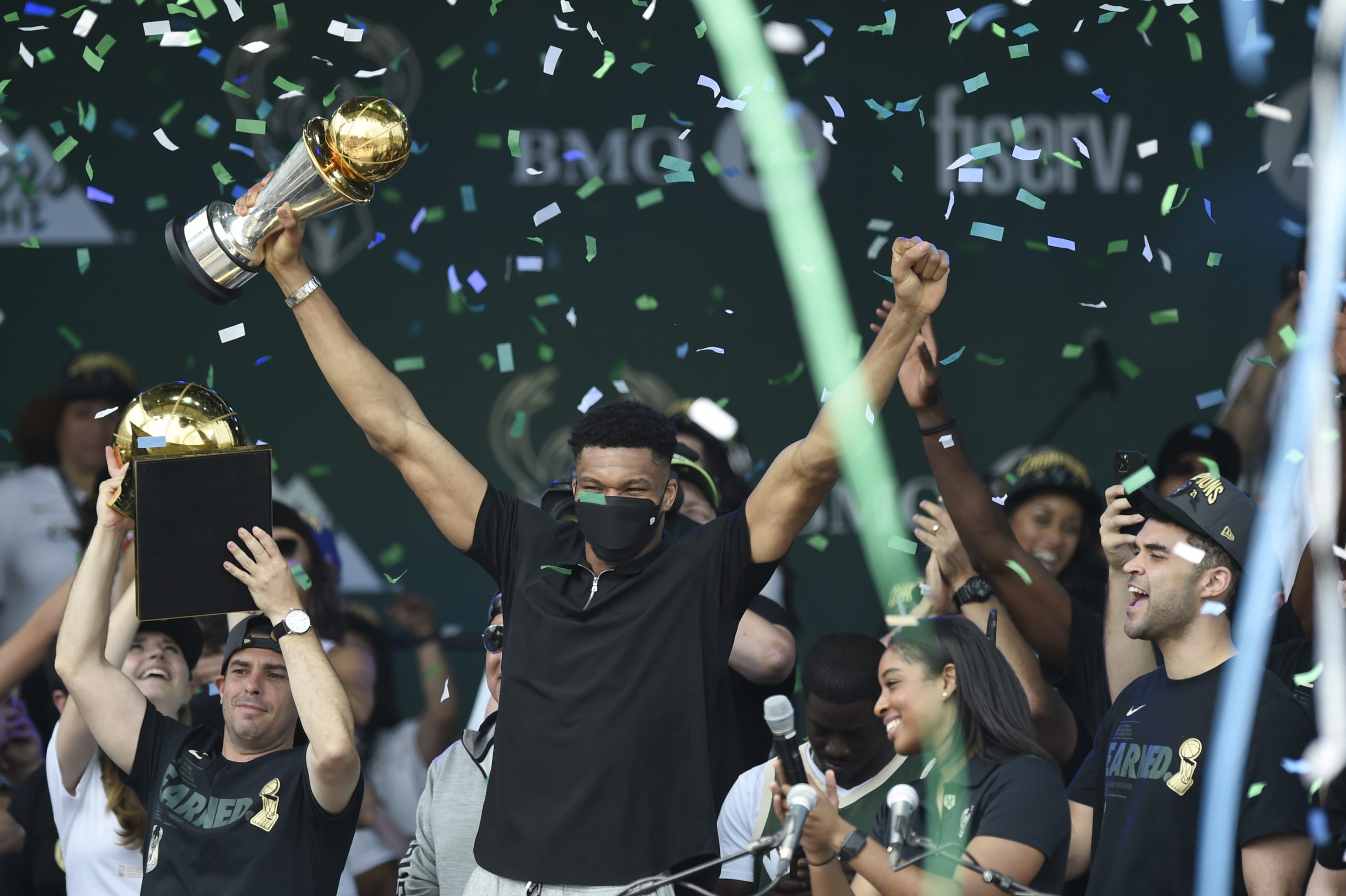 Giannis Antetokounmpo celebrates with the Larry O'Brien trophy.