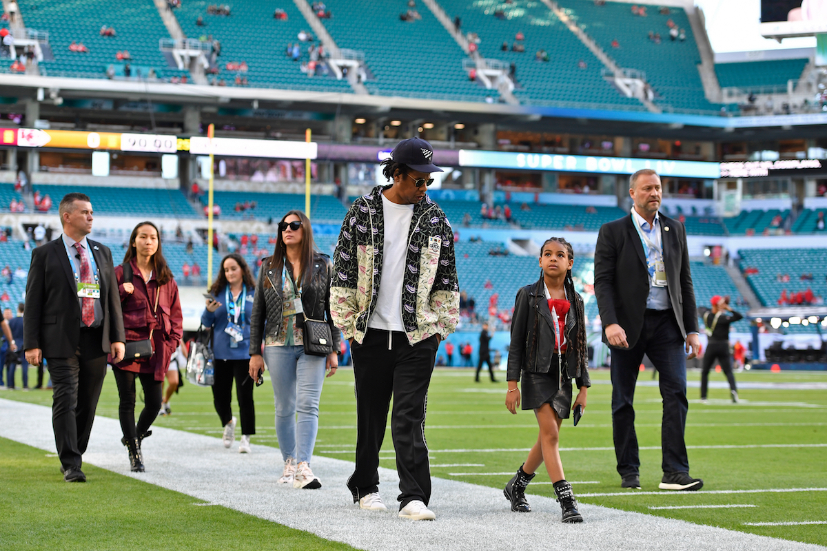 Jay-Z walks with his daughter Blue Ivy Carter as they tour the NFL field before the start of Super Bowl LIV