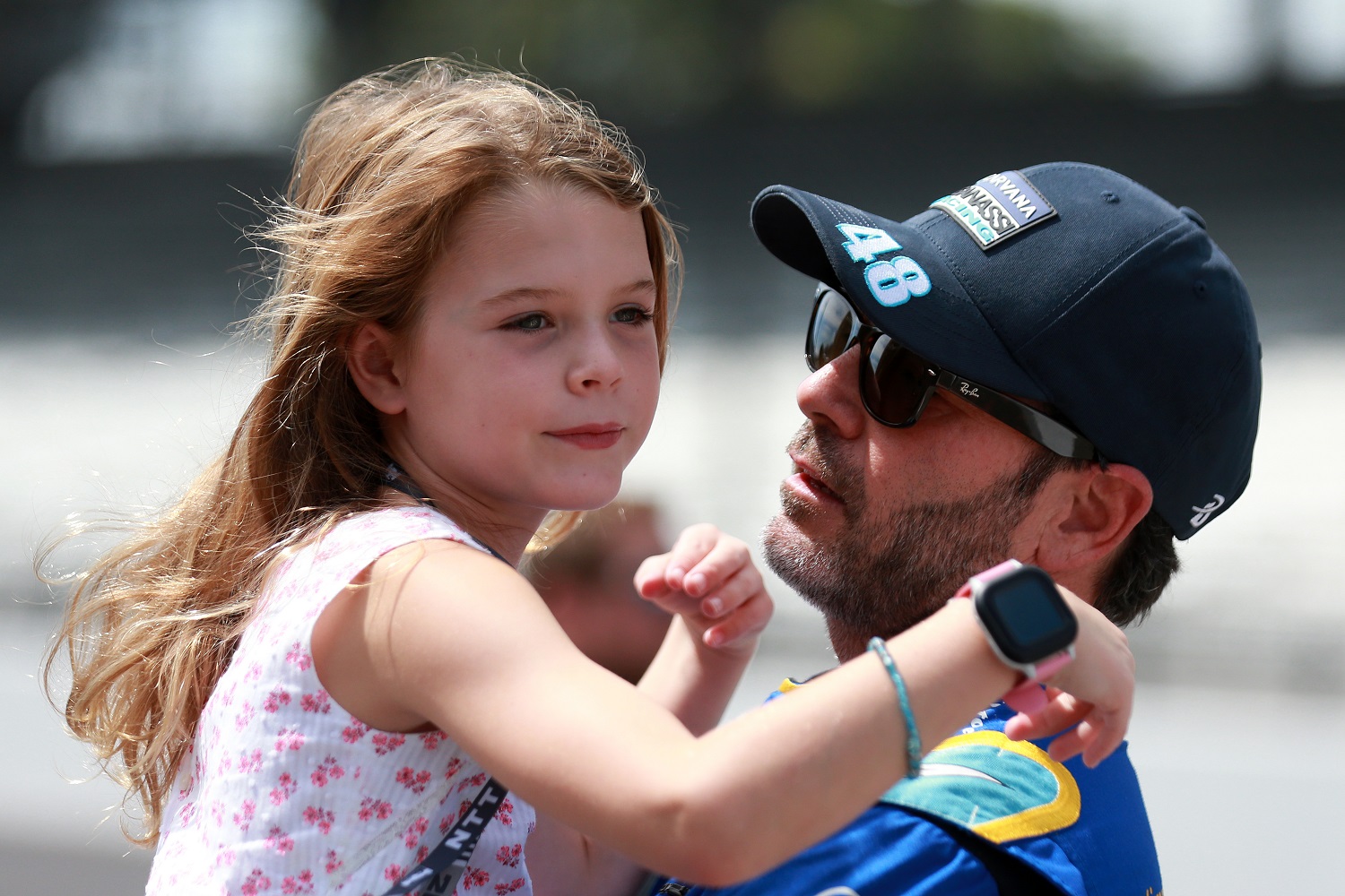 Jimmie Johnson, driver of the No. 48 Carvana Chip Ganassi Racing Honda, holds daughter Lydia on the grid prior to the NTT IndyCar Series Big Machine Spiked Coolers Grand Prix at Indianapolis Motor Speedway on Aug. 14, 2021.