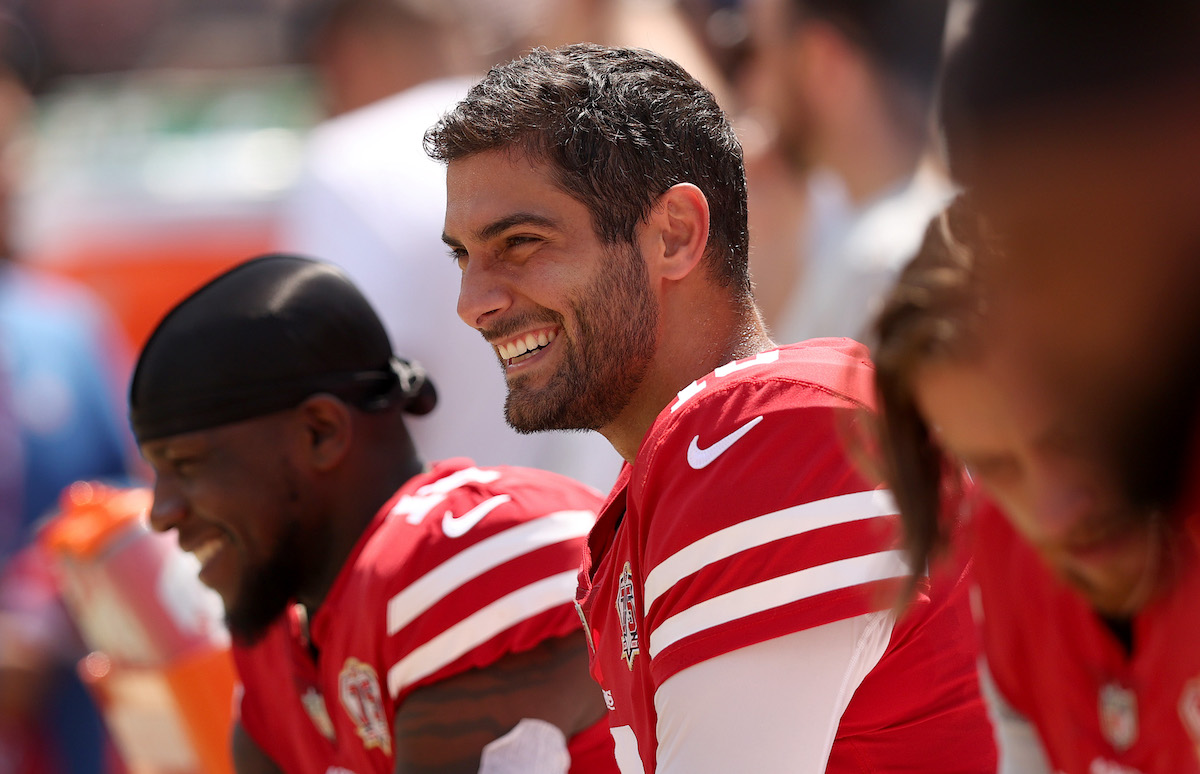 Jimmy Garoppolo of the San Francisco 49ers sits on the sideline