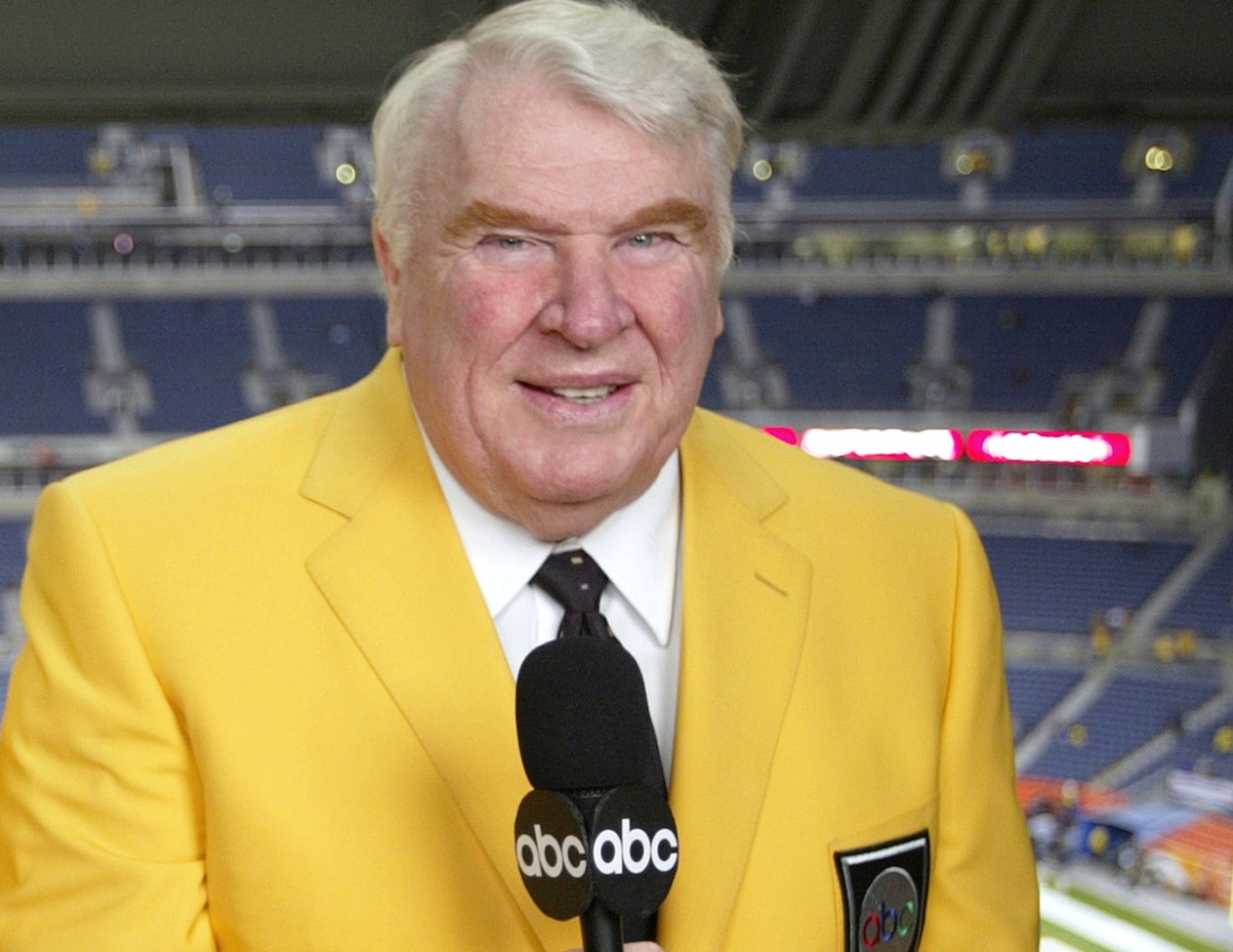 NFL legend John Madden holds the microphone while calling an NFL game in 200