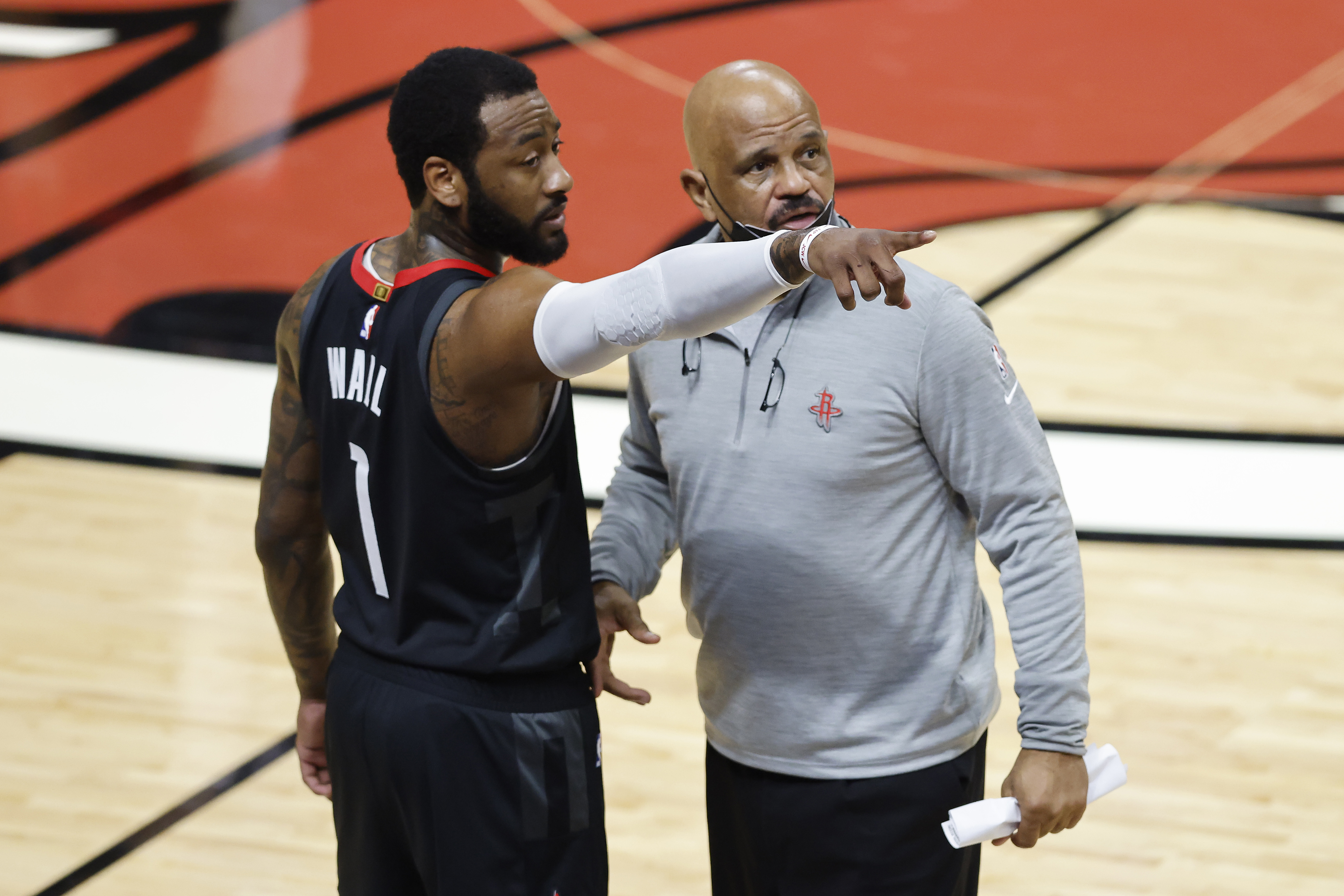 Rockets guard John Wall talks with assistant John Lucas II