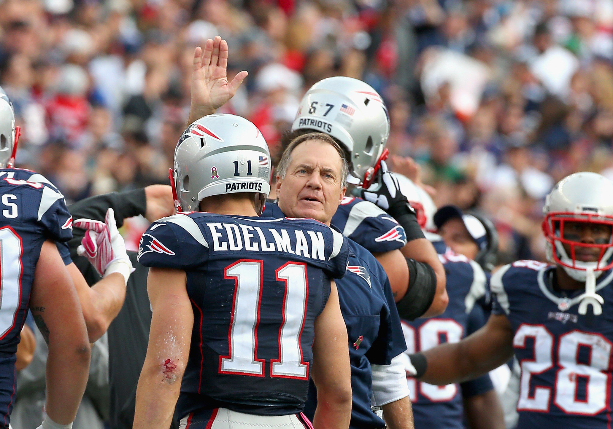 Head coach Bill Belichick reacts with Julian Edelman of the New England Patriots during the fourth quarter against the New York Jets.
