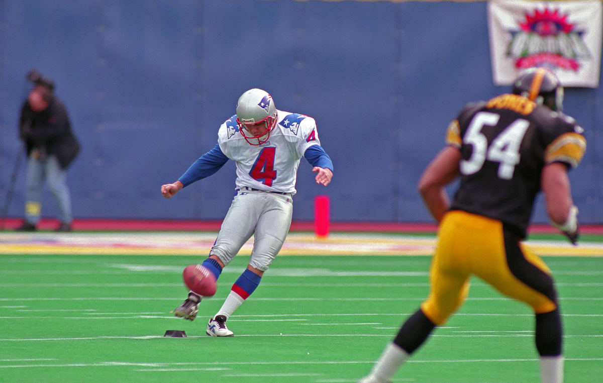 Kicker Adam Vinatieri of the New England Patriots kicks off during a 1997 season playoff game