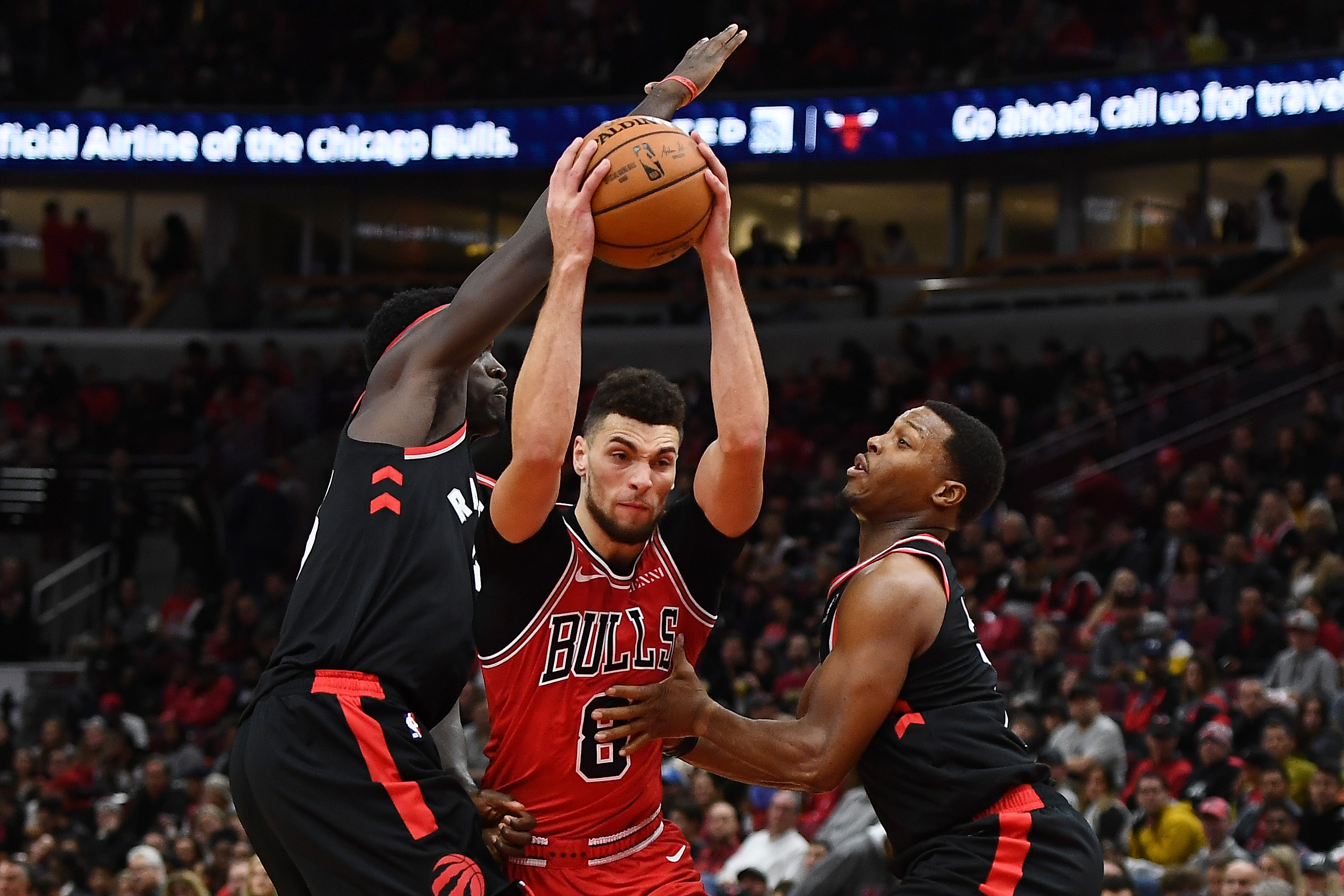 Kyle Lowry and Pascal Siakam defend a driving Zach LaVine during a game in fall 2019
