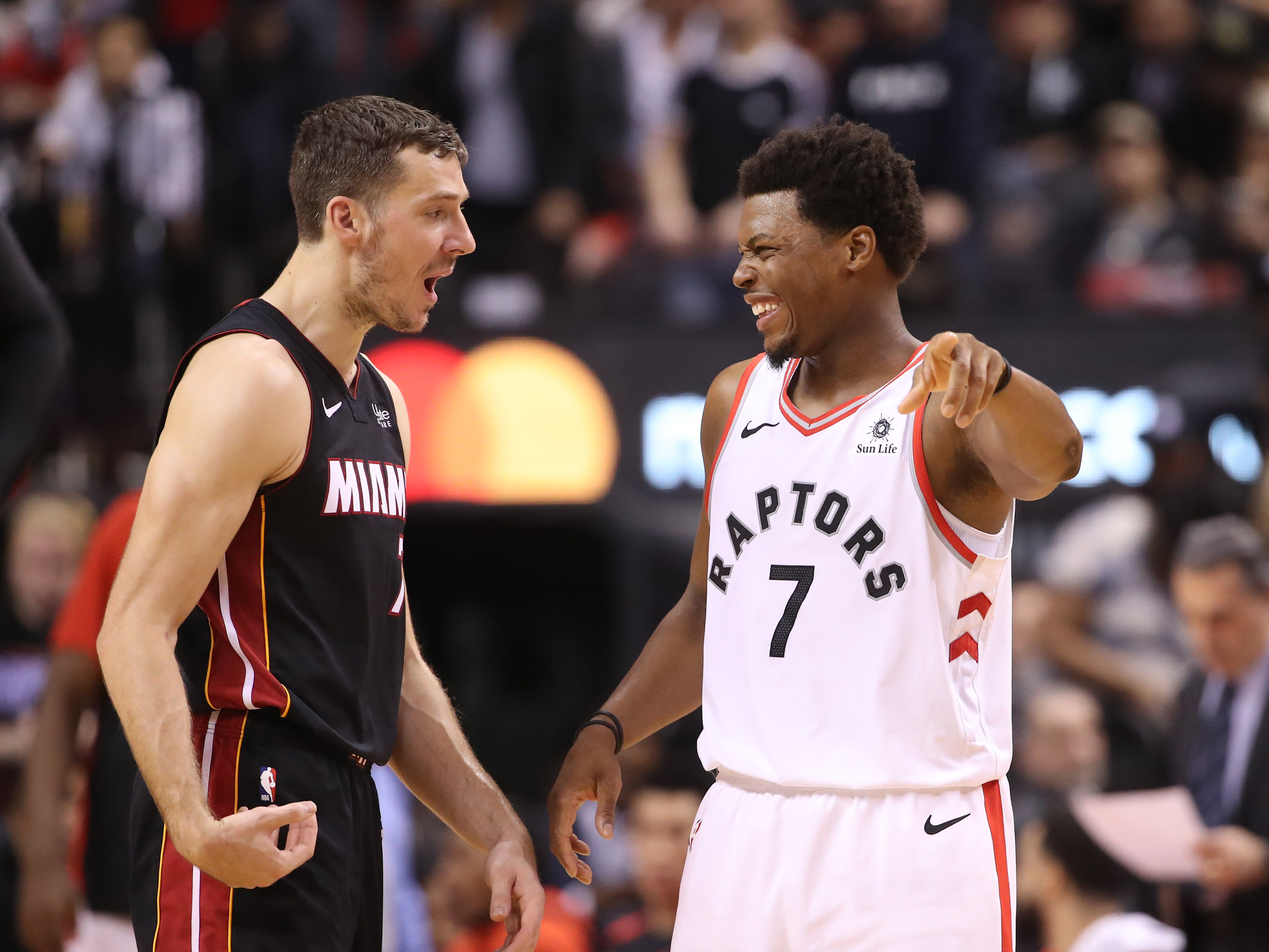 Former Heat guard Goran Dragic and Kyle Lowry talk during a game in 2019