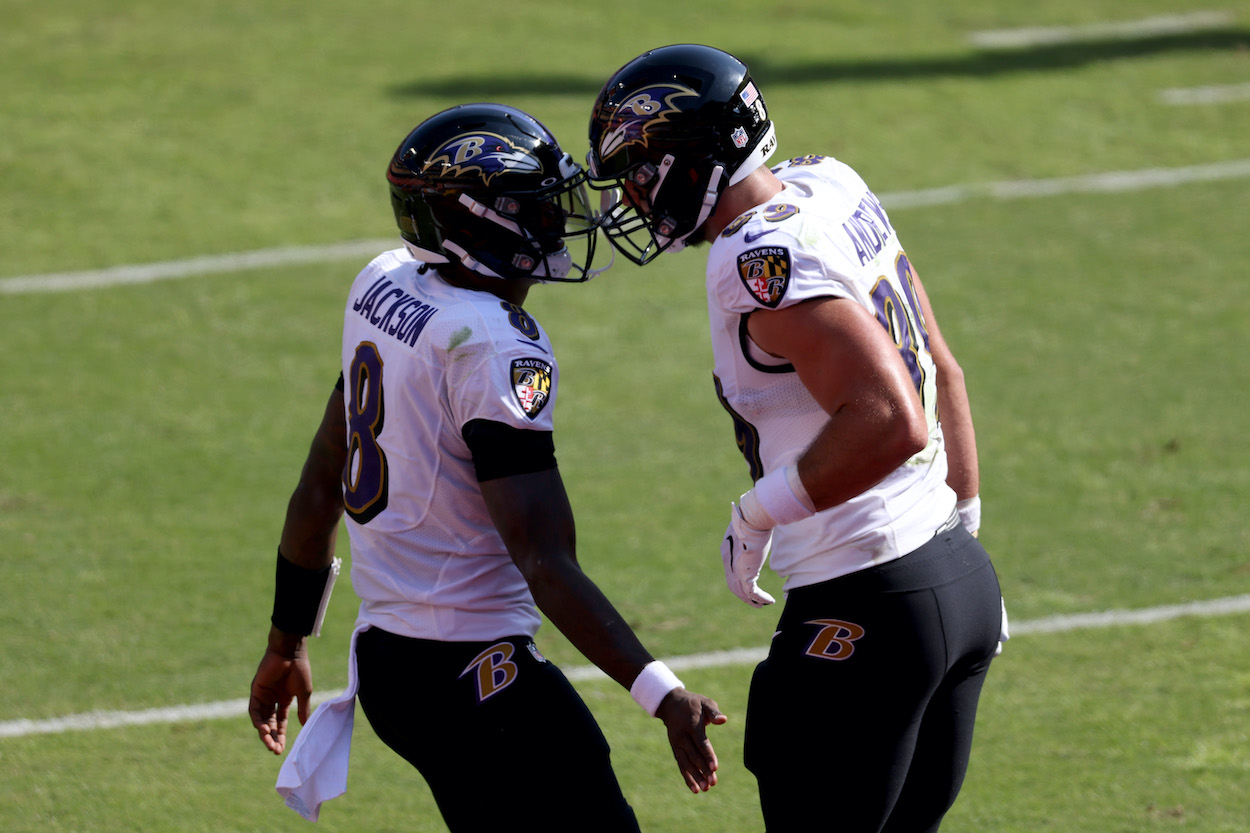 Tight end Mark Andrews of the Baltimore Ravens celebrates with quarterback Lamar Jackson after catching a second half touchdown pass against the Washington Football Team at FedExField on October 04, 2020 in Landover, Maryland.