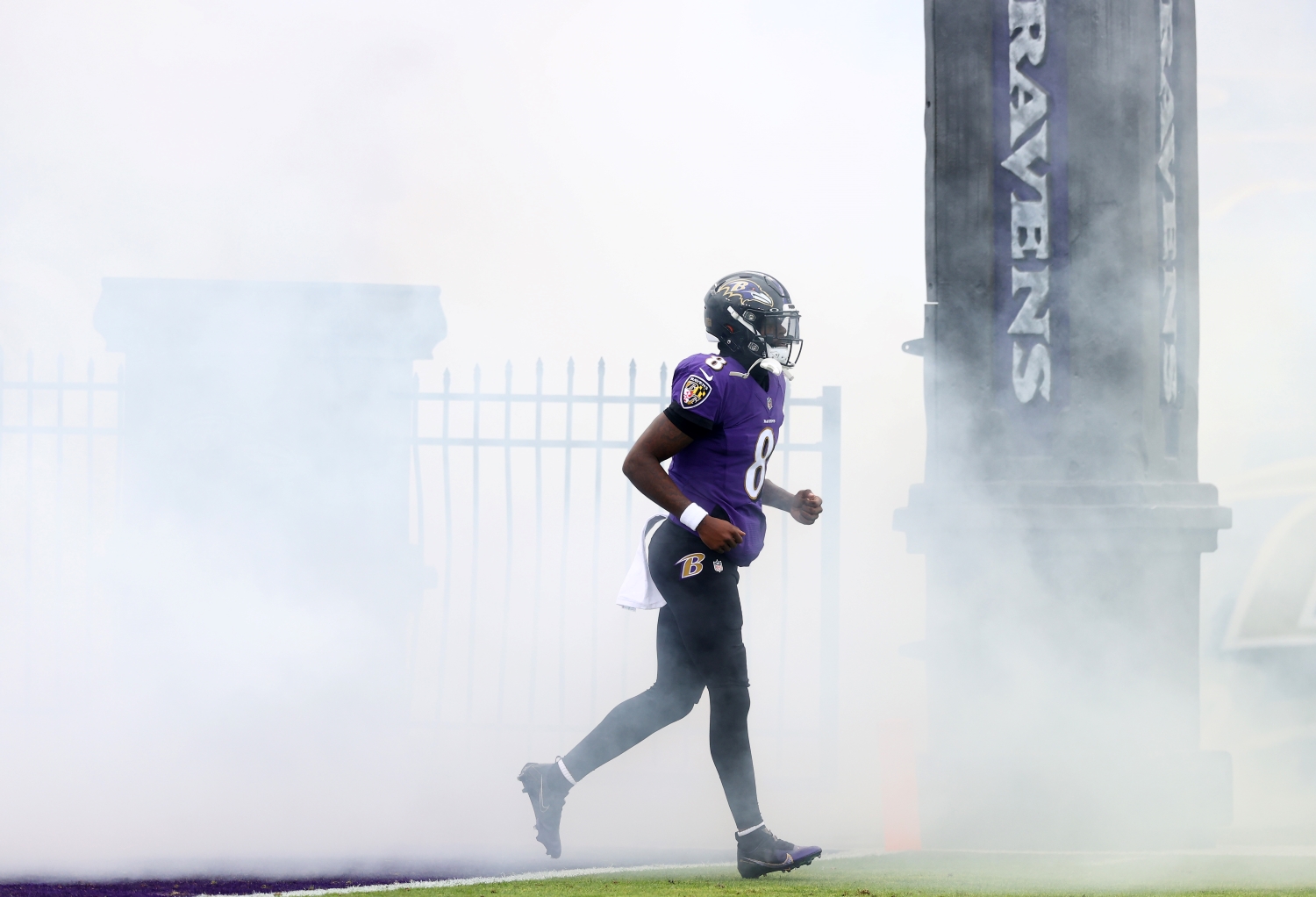 Baltimore Ravens quarterback Lamar Jackson jogs onto the field before a game.