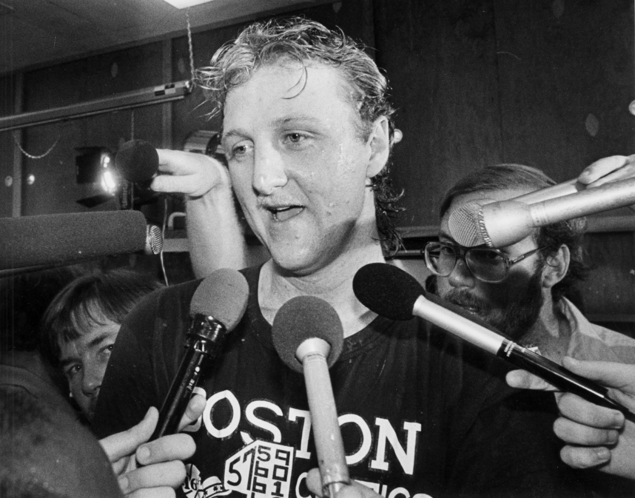 Larry Bird talks to the press in the locker room after winning a game against the Houston Rockets on June 8, 1986.