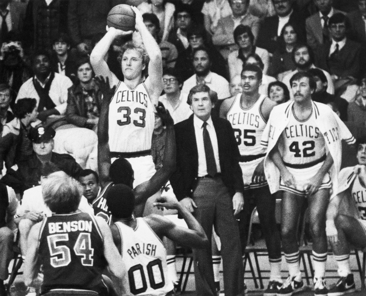 Detroit Pistons player Phil Hubbard tries to block Boston Celtics Larry Bird.