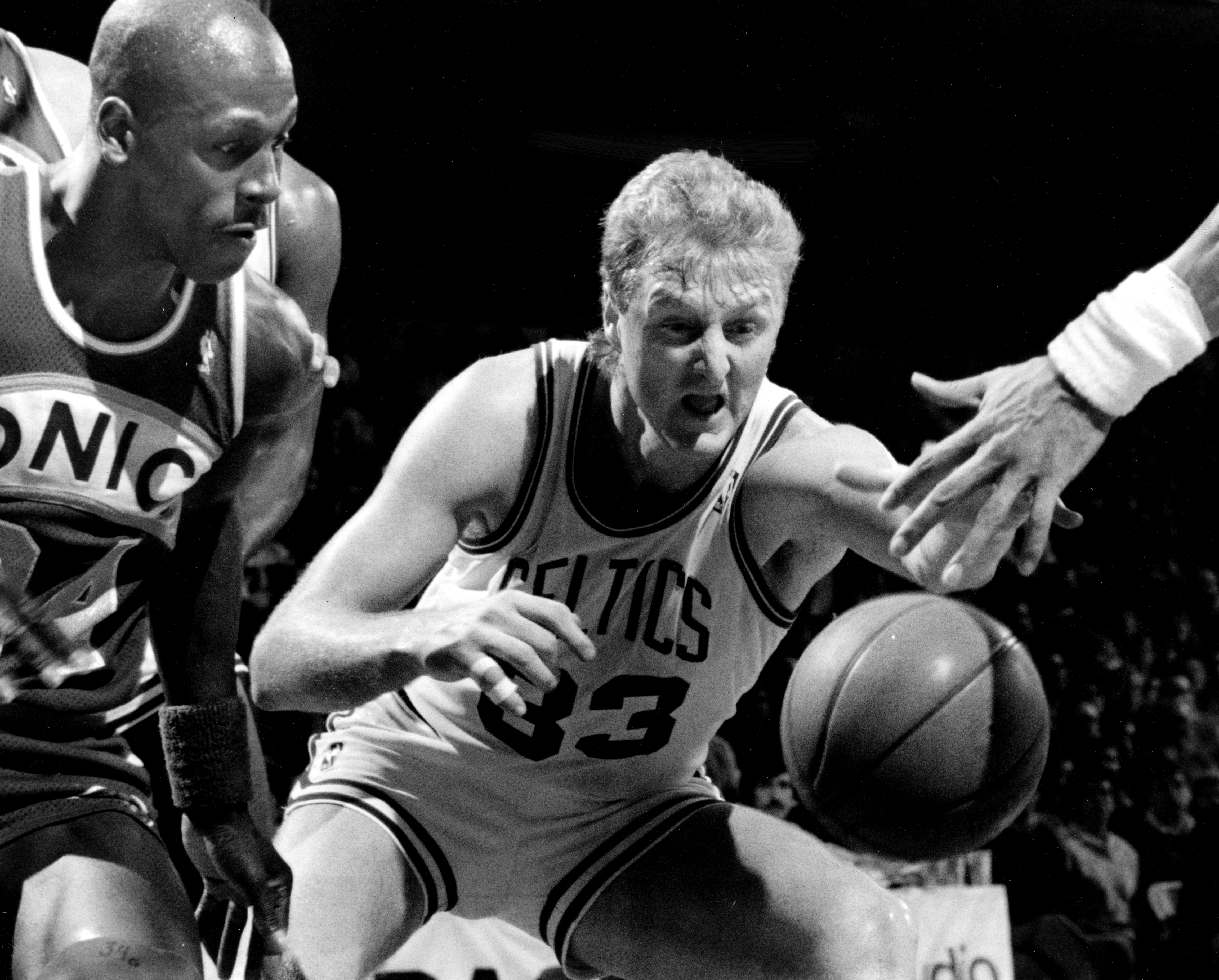 Larry Bird and Xavier McDaniel fight for a loose ball