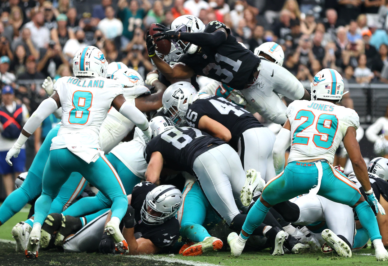 Peyton Barber of the Las Vegas Raiders scores on a rushing touchdown against the Miami Dolphins in the fourth quarter of the game at Allegiant Stadium on September 26, 2021 in Las Vegas, Nevada. Coach Jon Gruden gave Barber a game ball after the win.