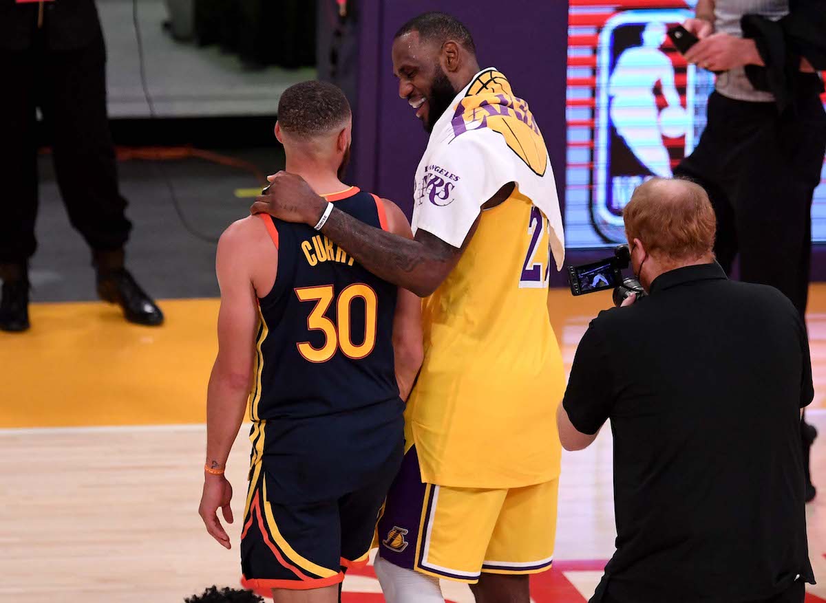 LeBron James of the Los Angeles Lakers hugs Stephen Curry of the Golden State Warriors