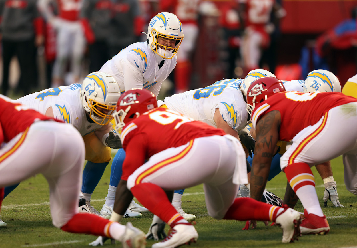 Quarterback Justin Herbert of the Los Angeles Chargers takes the snap during the game against the Kansas City Chiefs at Arrowhead Stadium on January 03, 2021 in Kansas City, Missouri. The two teams face off this week as one of the three most intriguing matchups of NFL Week 3