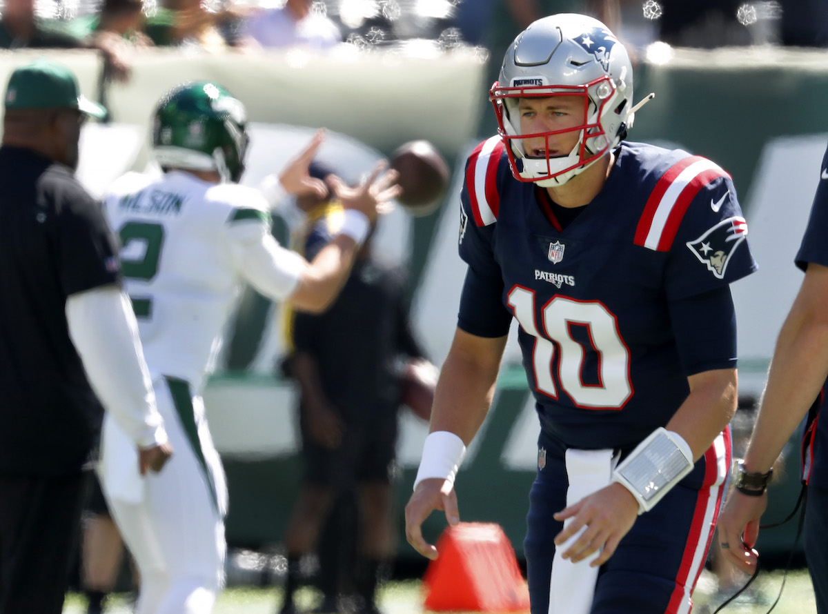 Patriots rookie quarterback Mac Jones (#10) and Jets rookie quarterback Zach Wilson (#2, left) warm up before their September 19 game