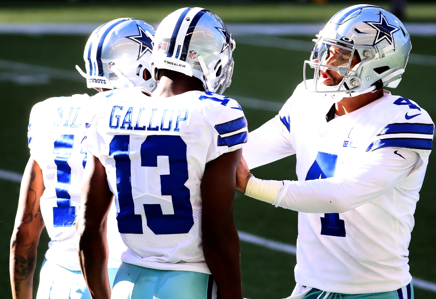 Dak Prescott celebrates a play with Dallas Cowboys teammates Cedrick Wilson Jr. and Michael Gallup.