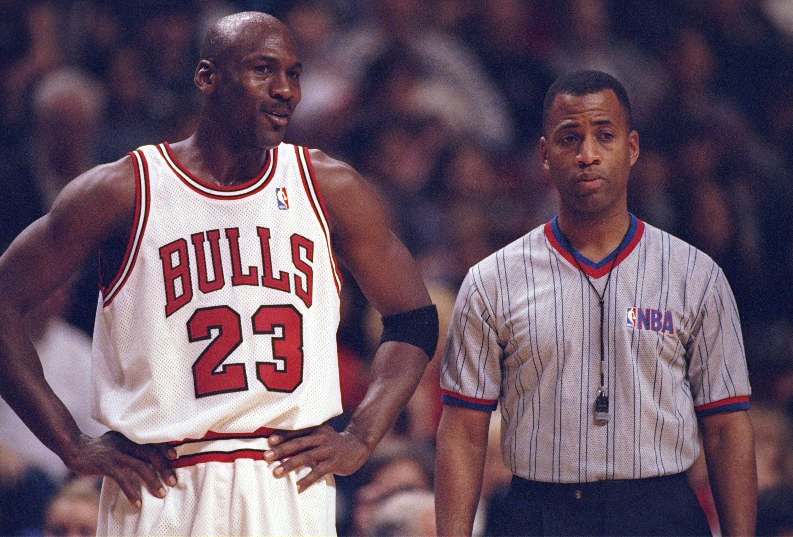 Michael Jordan of the Chicago Bulls confers with an official.