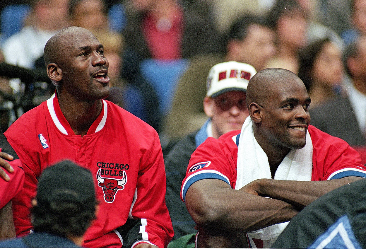 Michael Jordan of the Chicago Bulls sits on the bench with Chris Webber during an NBA All-Star Game.