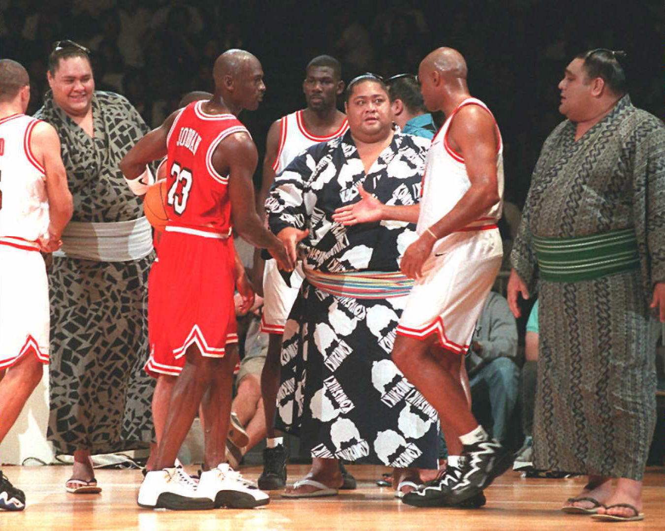 Bulls legend Michael Jordan and Hall of Fame forward Charles Barkley shake hands after an exhibition game in Japan
