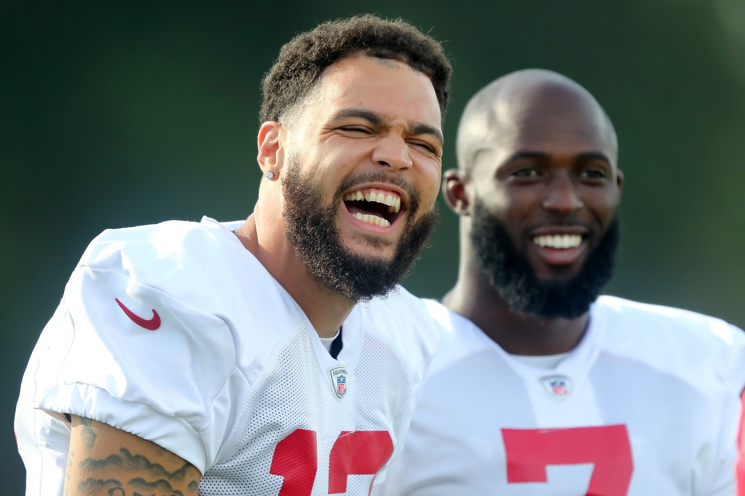 Mike Evans has a laugh as Leonard Fournette smiles in background during the Tampa Bay Buccaneers' training camp on July 27, 2021.