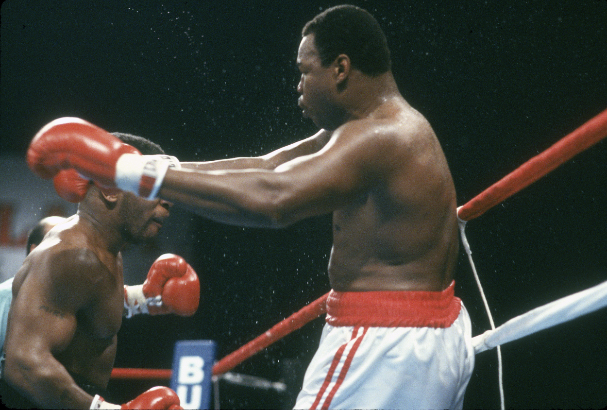Larry Holmes and Mike Tyson fight for the WBA, WBC and IBF heavyweight title on January 22, 1988.