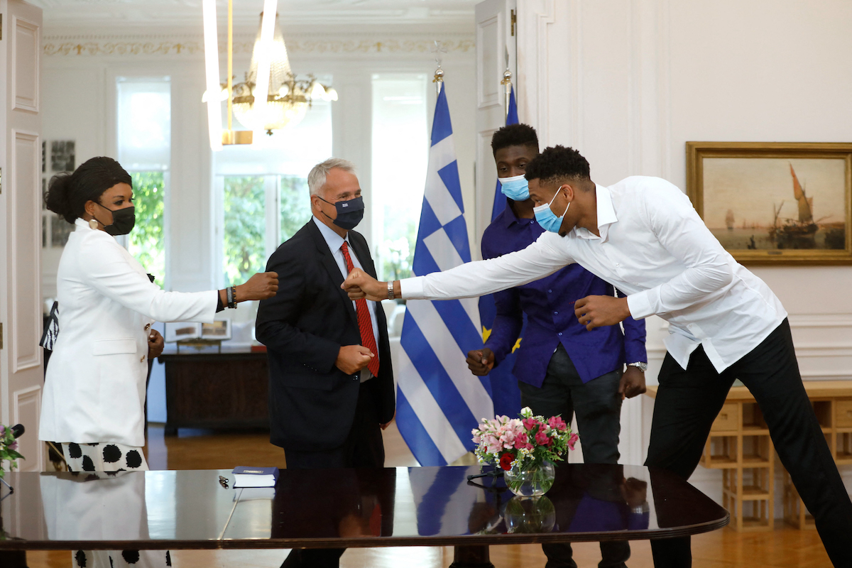 Milwaukee Bucks forward Giannis Antetokounmpo, his mother, and his brother Alex Antetokounmpo first bump in Greece